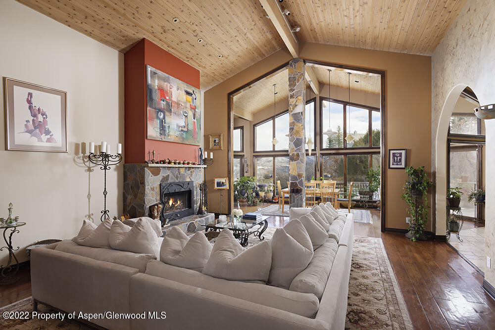 a living room with furniture fireplace and a large window