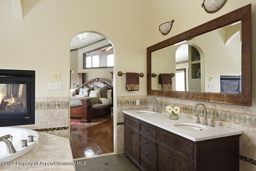 2345 Juniper Hill Road Aspen, CO 81611 - Photo 16 of 26 a en suite bathroom with double vanity and a mirror