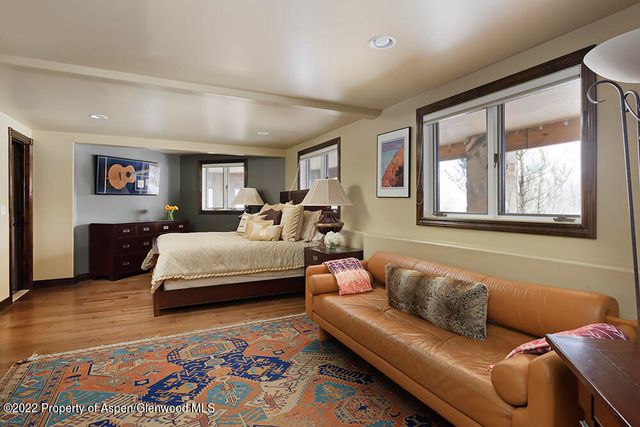 a bedroom with furniture and a rug