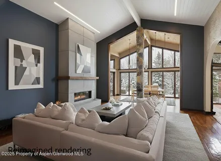 a living room with furniture fireplace and a large window