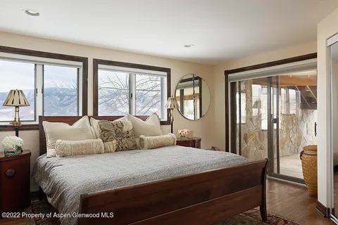 a bedroom with a large bed and a large window