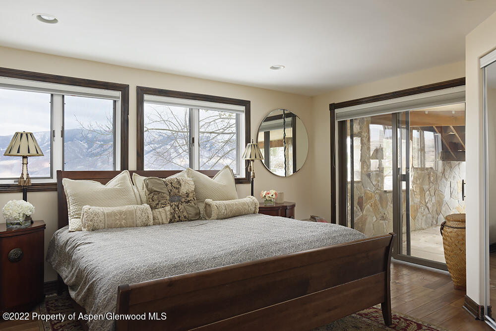 2345 Juniper Hill Road Aspen, CO 81611 - Photo 23 of 26 a bedroom with a large bed and a large window