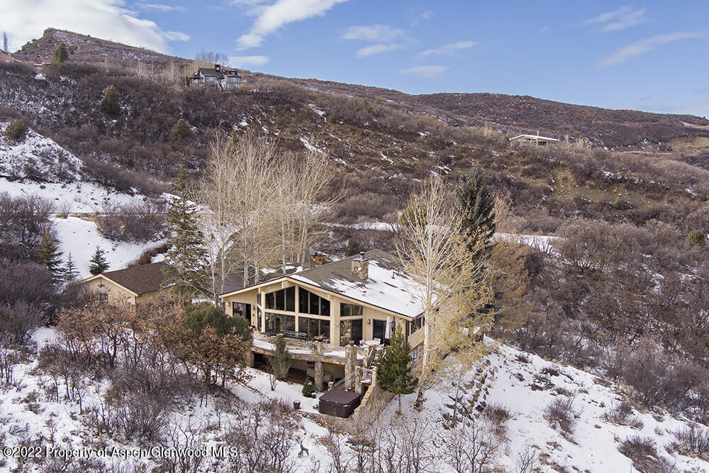 2345 Juniper Hill Road Aspen, CO 81611 - Photo 26 of 26 a view of a big house with a mountain in the background
