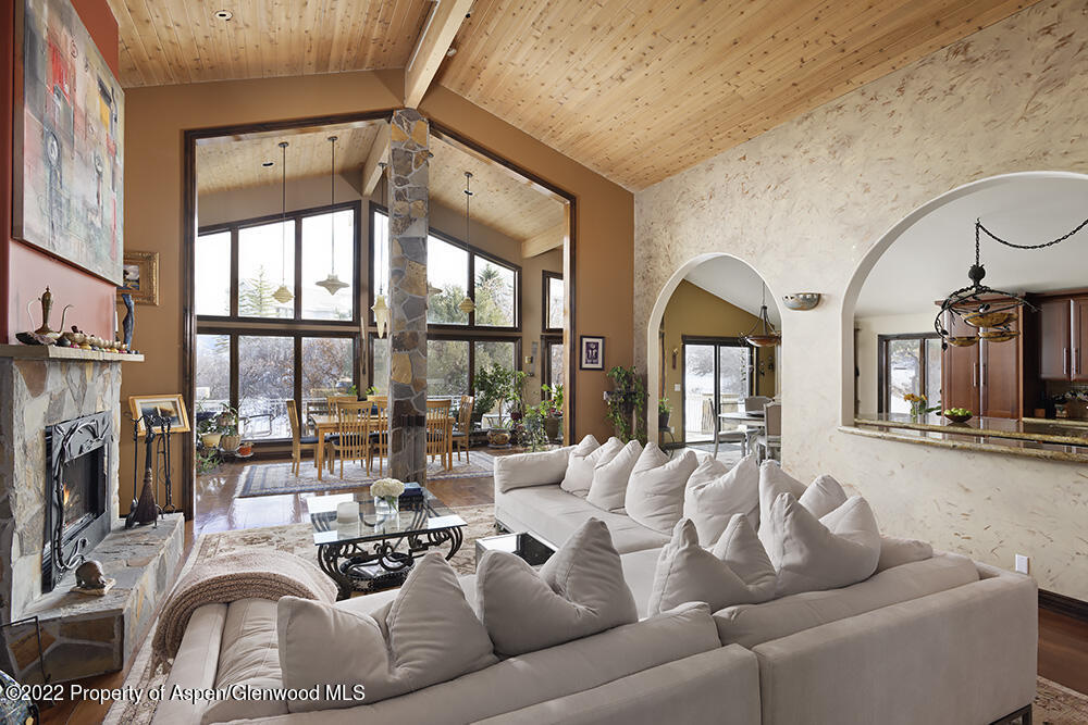 2345 Juniper Hill Road Aspen, CO 81611 - Photo 4 of 26 a living room with furniture a fireplace and floor to ceiling windows