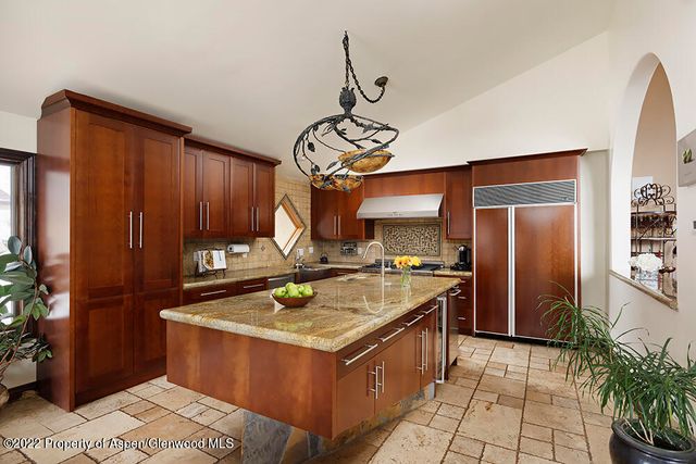 a kitchen with a stove top oven cabinets and a counter top space