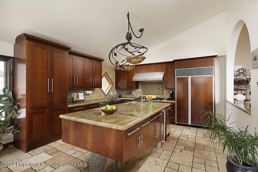 2345 Juniper Hill Road Aspen, CO 81611 - Photo 7 of 26 a kitchen with a stove top oven cabinets and a counter top space
