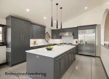 a kitchen with a sink a refrigerator and a stove top oven