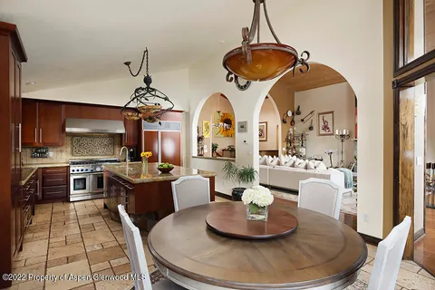a living room with furniture and kitchen view