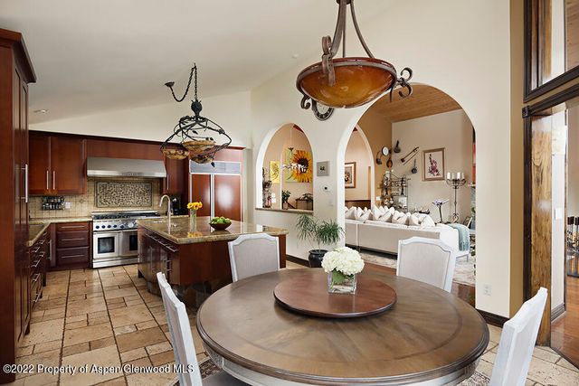 a living room with furniture and kitchen view