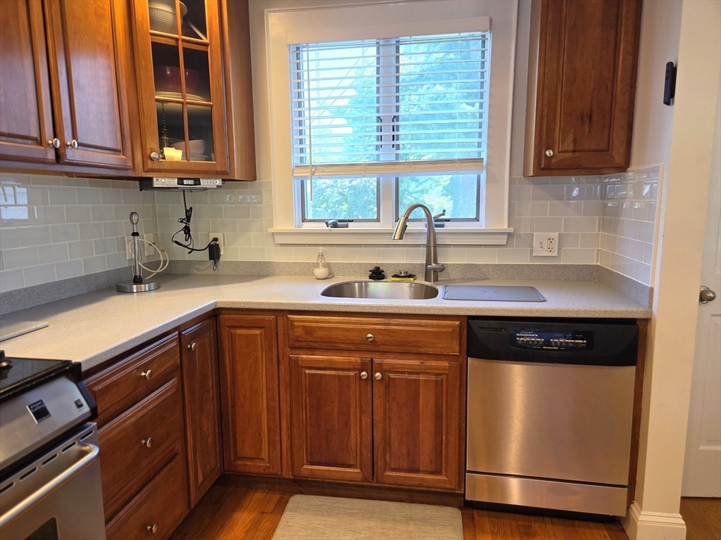 25 Waldeck Road Milton, MA 02186 - Photo 9 of 34 a kitchen with granite countertop cabinets sink and window