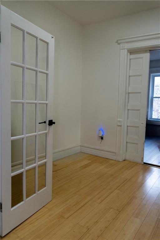 43 Linden Street Brooklyn, NY 11221 - Photo 5 of 9 a view of an empty room with a window and wooden floor