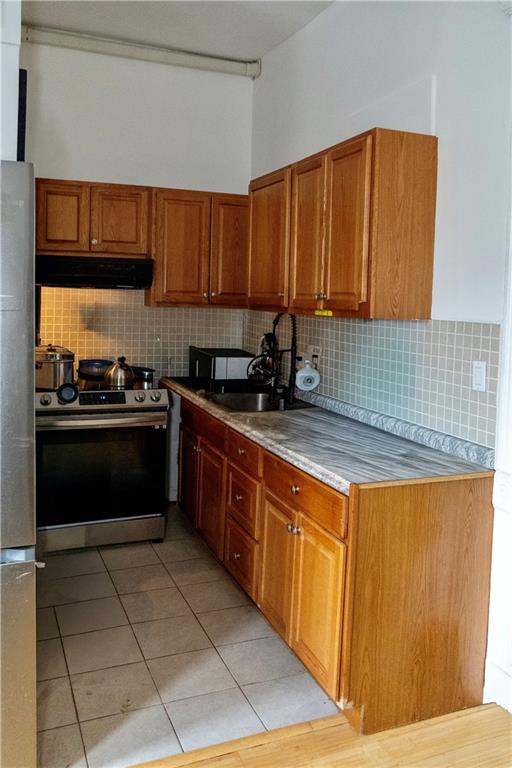 43 Linden Street Brooklyn, NY 11221 - Photo 8 of 9 a kitchen with stainless steel appliances a sink stove and cabinets