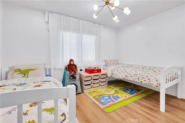 a living room with baby crib furniture and a table