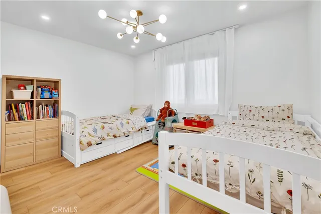 a bedroom with furniture and a baby crib