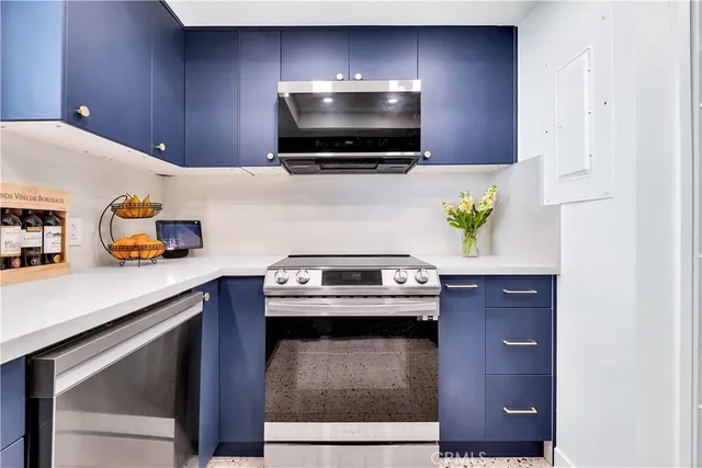 a kitchen with stainless steel appliances a stove a microwave and cabinets