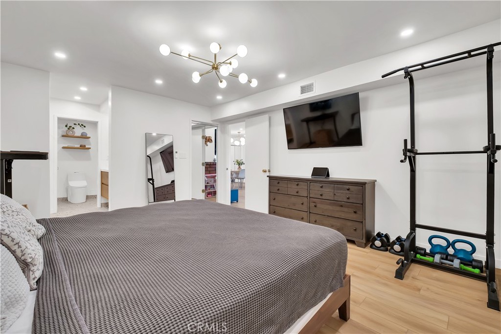 745 Main Street, Unit 107 El Segundo, CA 90245 - Photo 25 of 40 a spacious bedroom with a bed a flat screen tv and a couch