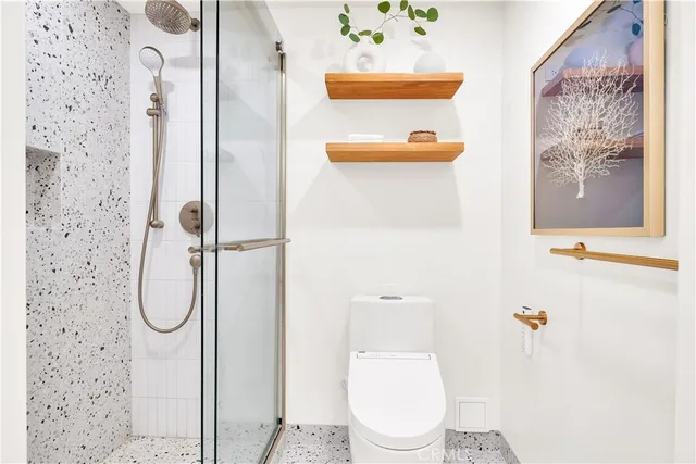 a bathroom with a toilet and a shower