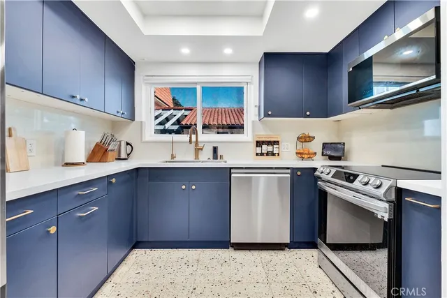 a kitchen with stainless steel appliances granite countertop a sink stove and cabinets