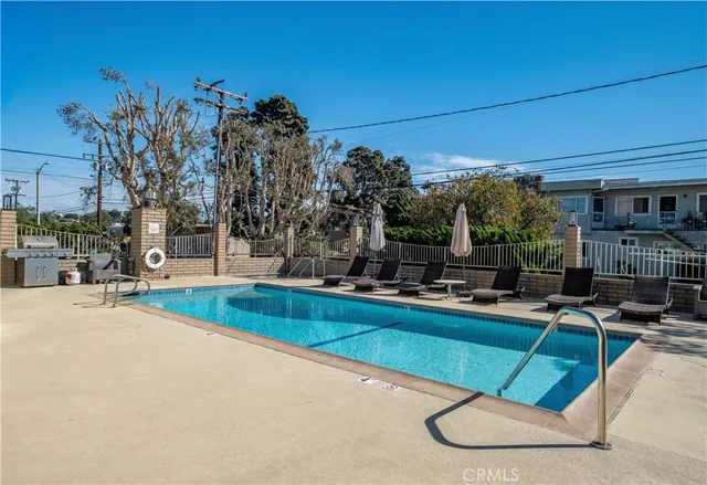 a view of a swimming pool with sitting area