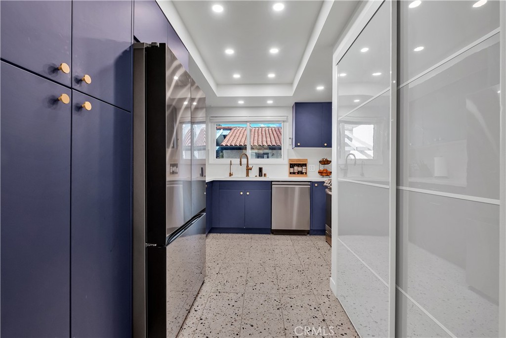 745 Main Street, Unit 107 El Segundo, CA 90245 - Photo 5 of 40 a kitchen with stainless steel appliances granite countertop a refrigerator a sink and a microwave