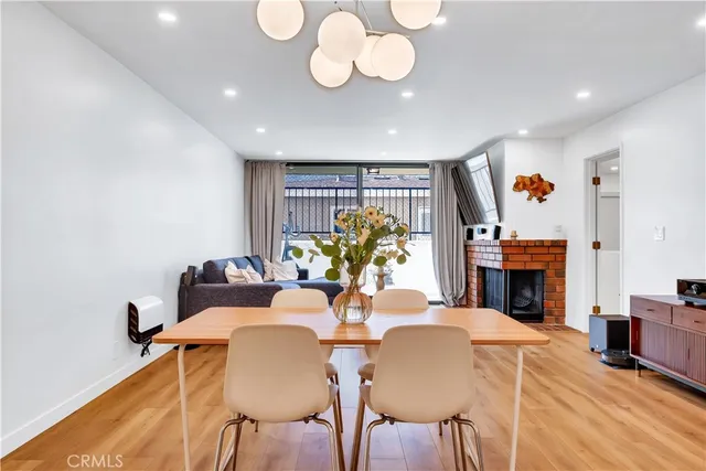 a view of a dining room with furniture and a fireplace