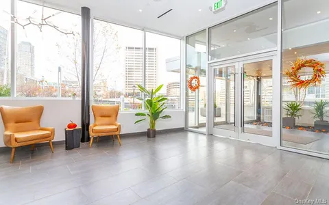 a lobby with furniture and floor to ceiling window