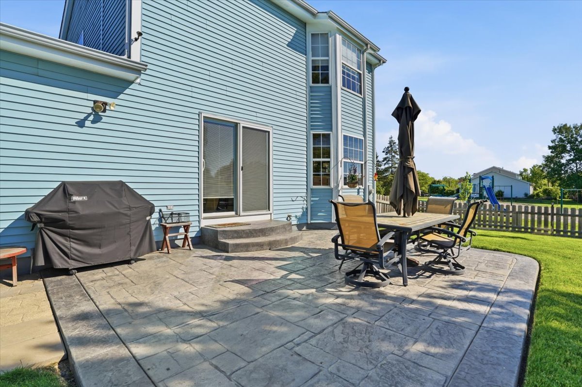 3413 Harbor Ridge Drive Zion, IL 60099 - Photo 28 of 37 a view of a patio with table and chairs and wooden floor
