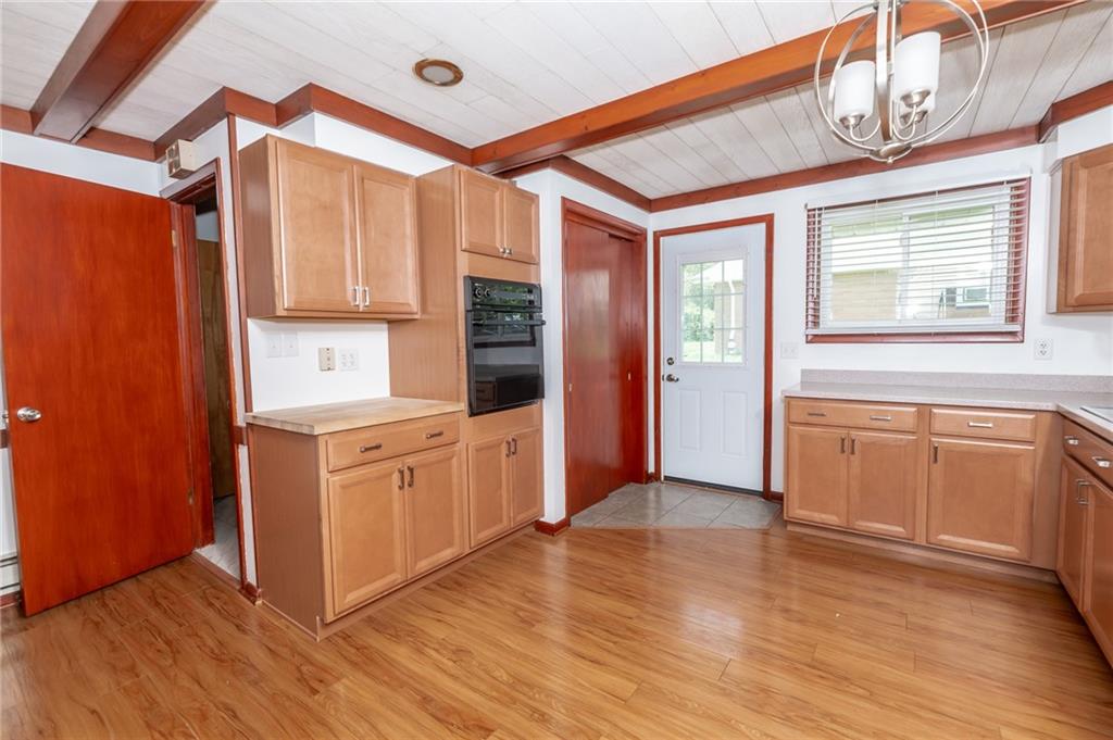 225 Courtland Road Indiana, PA 15701 - Photo 13 of 38 a kitchen with stainless steel appliances granite countertop a refrigerator a sink dishwasher and wooden cabinets with wooden floor