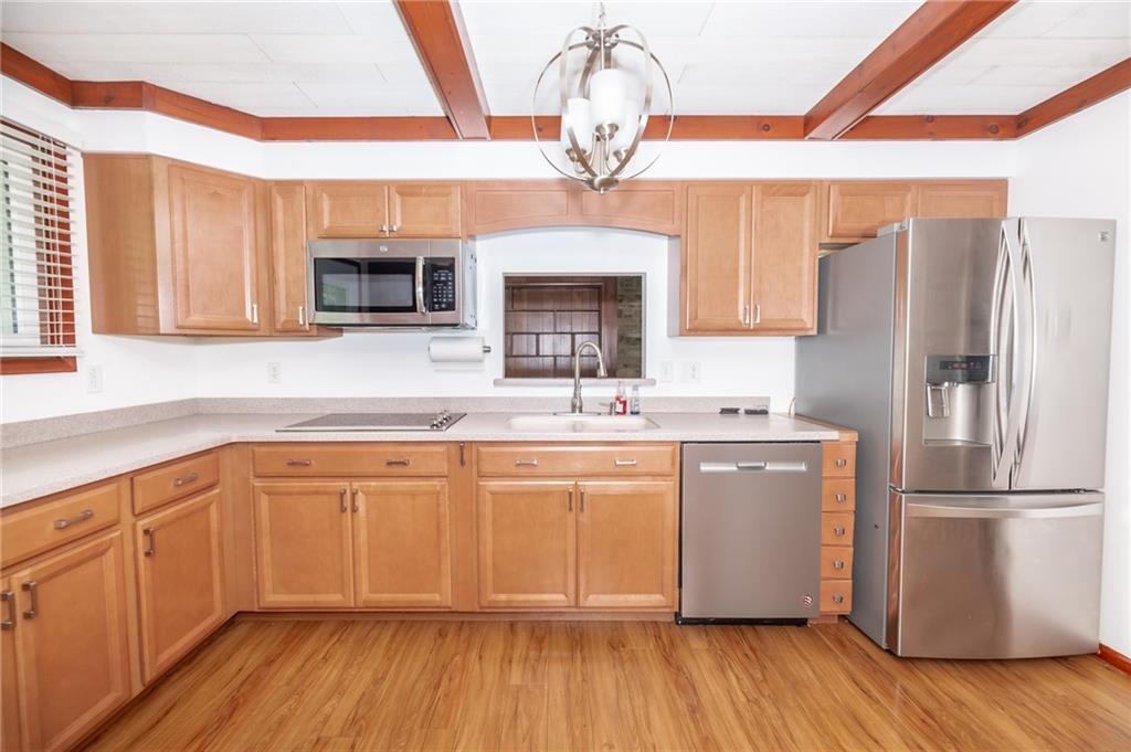 225 Courtland Road Indiana, PA 15701 - Photo 14 of 38 a kitchen with stainless steel appliances granite countertop a refrigerator a sink dishwasher a stove and white countertops with wooden floor