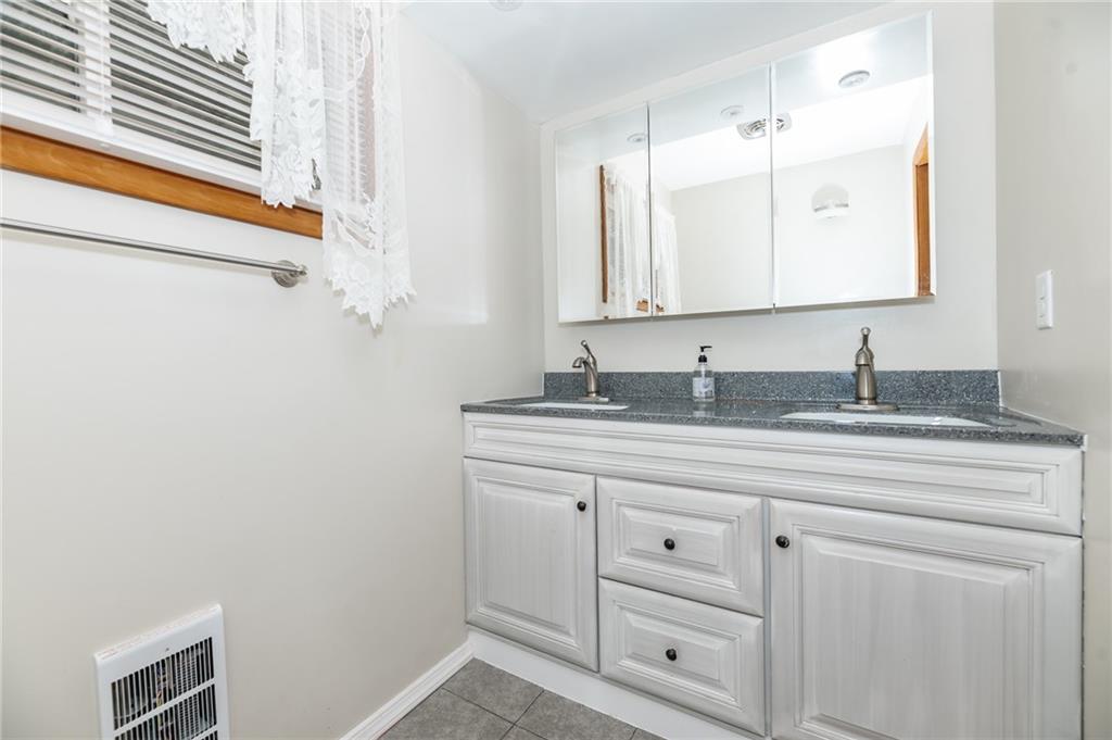 225 Courtland Road Indiana, PA 15701 - Photo 22 of 38 a bathroom with a granite countertop sink and a mirror