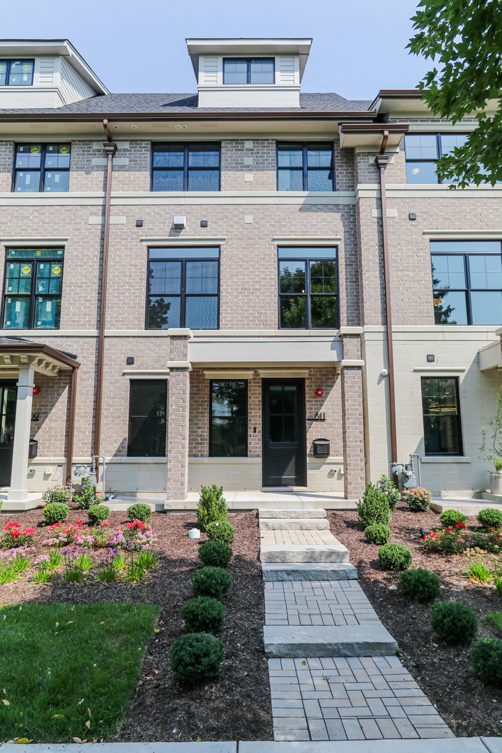 116 North Wright Street, Unit 5 Naperville, IL 60540 - Photo 2 of 62 a front view of a house with a yard and potted plants