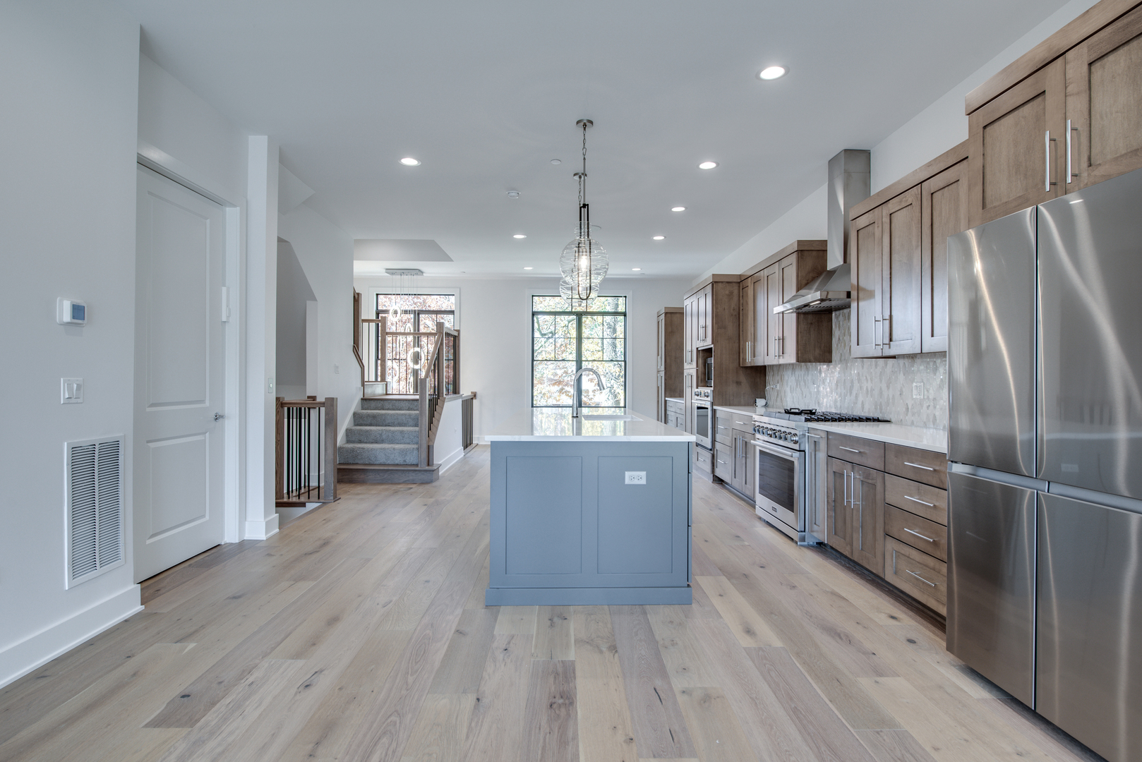 116 North Wright Street, Unit 5 Naperville, IL 60540 - Photo 41 of 62 a large kitchen with stainless steel appliances granite countertop a refrigerator a sink dishwasher a stove and a microwave oven on the wooden floor