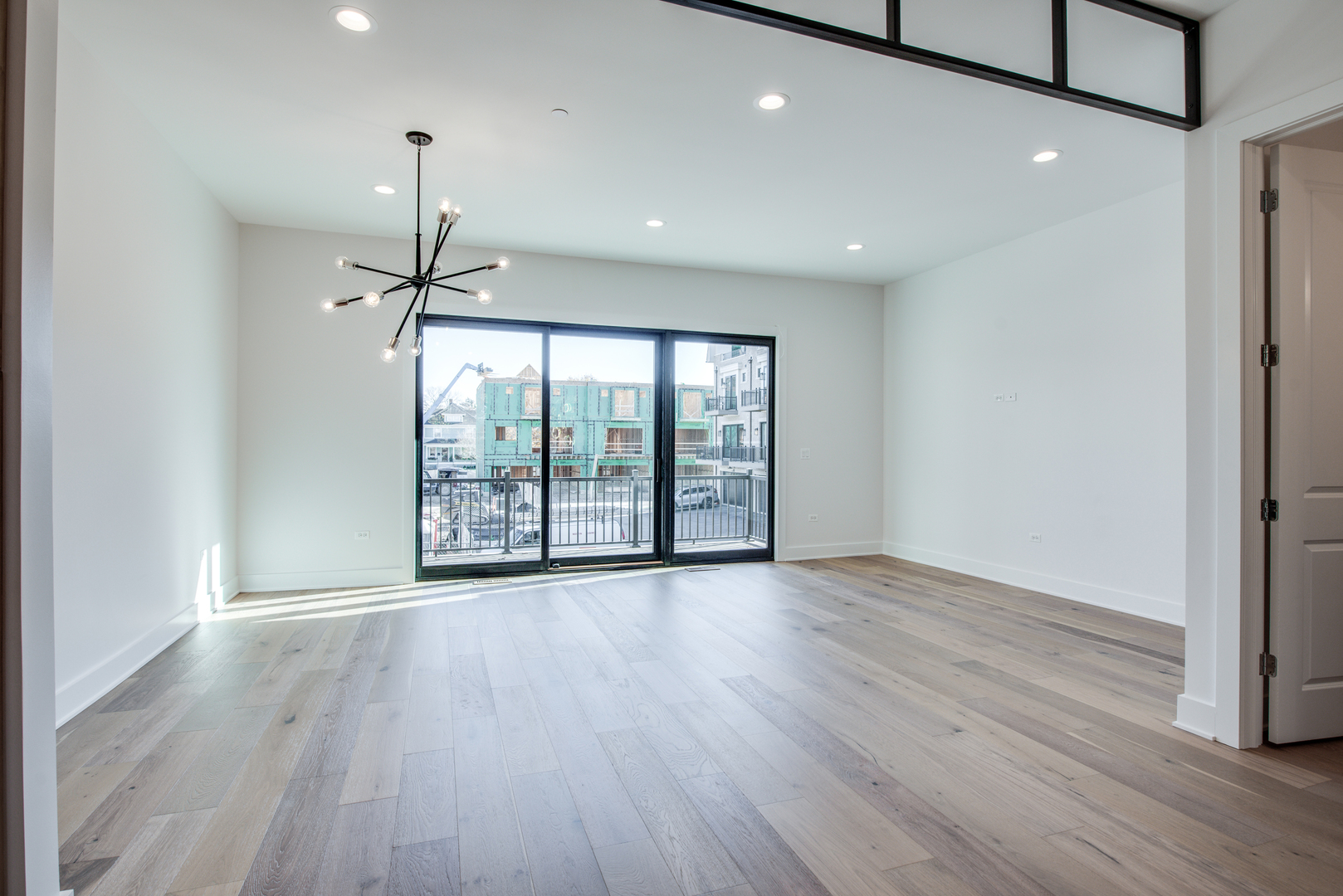 116 North Wright Street, Unit 5 Naperville, IL 60540 - Photo 42 of 62 a view of an empty room with wooden floor fan and a window