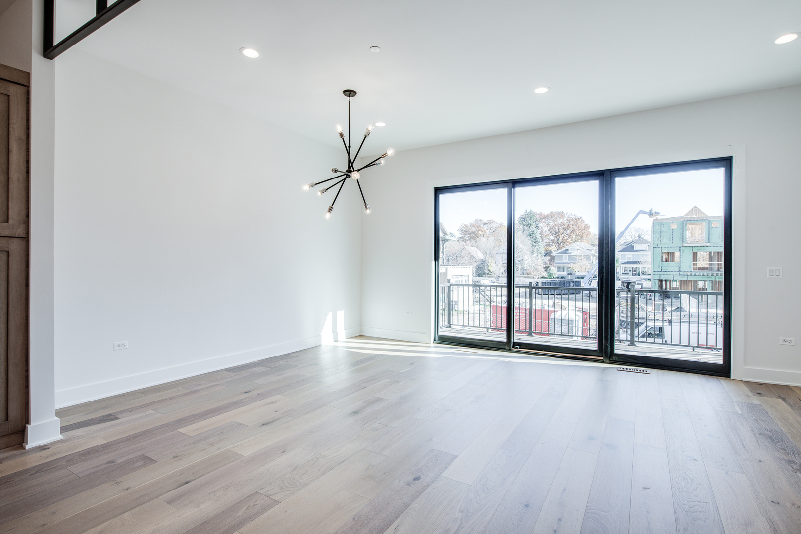 116 North Wright Street, Unit 5 Naperville, IL 60540 - Photo 43 of 62 a view of an empty room with wooden floor and a window