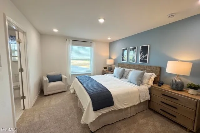 a bedroom with a bed chair and window