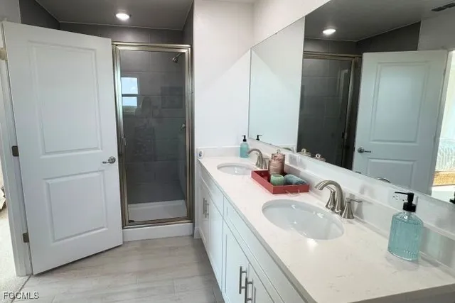 a bathroom with a granite countertop sink a toilet and shower