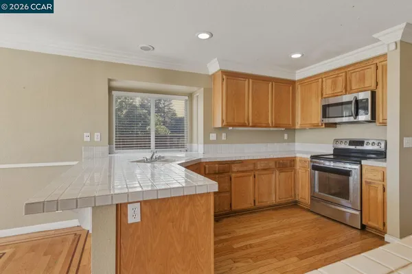 a kitchen with granite countertop wooden cabinets a sink and dishwasher