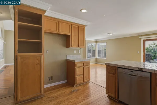 a large kitchen with kitchen island granite countertop a large counter top stainless steel appliances and cabinets