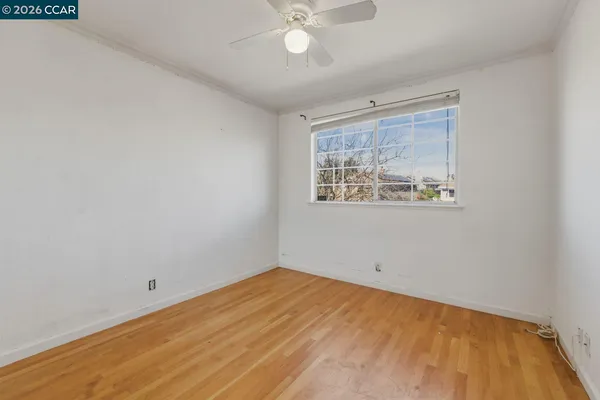 a bedroom with a bed and a potted plant