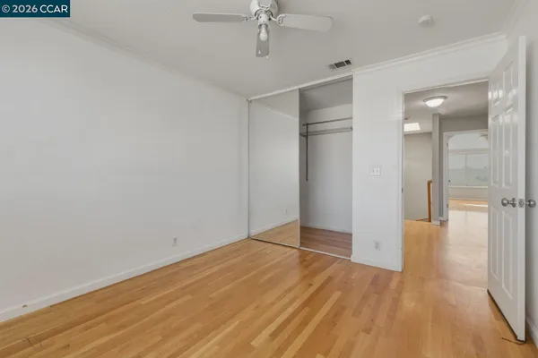 a bedroom with a bed couch and window