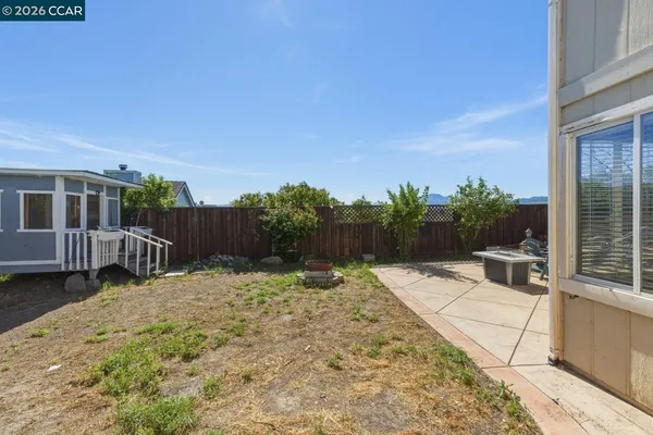 a view of a house with backyard and sitting area
