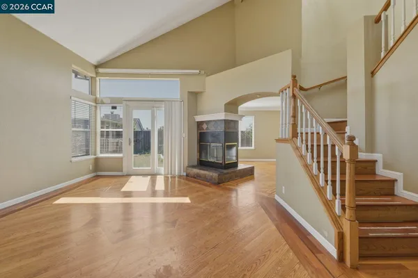 a view of an entryway with a floor to ceiling window and a kitchen