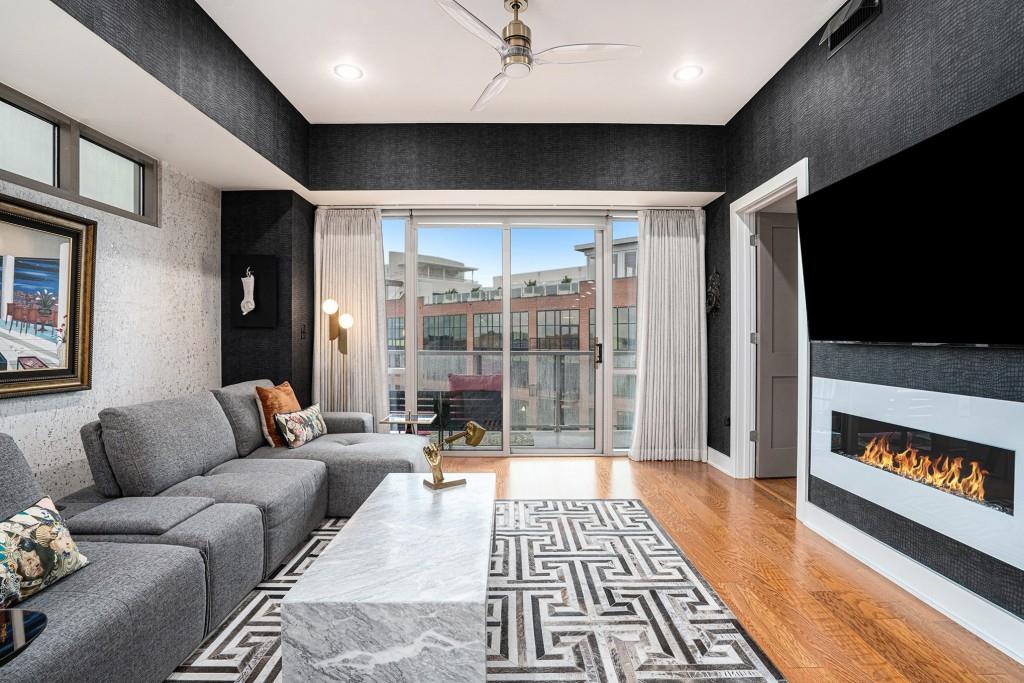 1100 Howell Mill Road Northwest, Unit 808 Atlanta, GA 30318 - Photo 13 of 48 a living room with furniture and a flat screen tv