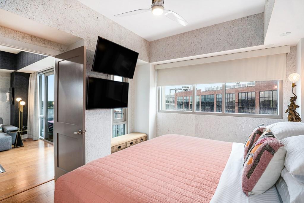 1100 Howell Mill Road Northwest, Unit 808 Atlanta, GA 30318 - Photo 24 of 48 a bedroom with a bed and a flat screen tv