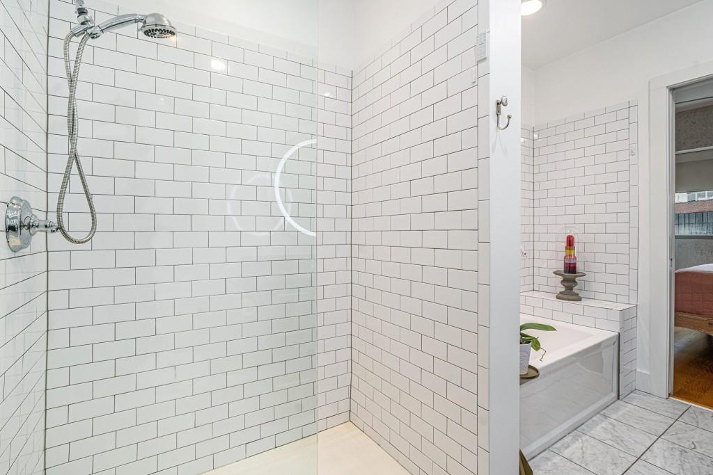 1100 Howell Mill Road Northwest, Unit 808 Atlanta, GA 30318 - Photo 27 of 48 a bathroom with a bathtub and shower
