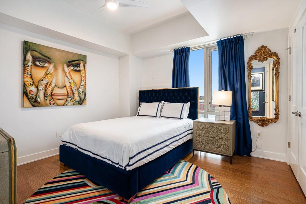 1100 Howell Mill Road Northwest, Unit 808 Atlanta, GA 30318 - Photo 30 of 48 a bedroom with a bed and wooden floor