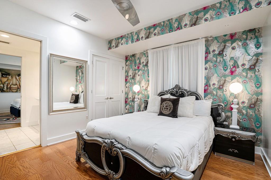 1100 Howell Mill Road Northwest, Unit 808 Atlanta, GA 30318 - Photo 35 of 48 a bedroom with a bed and wooden floor