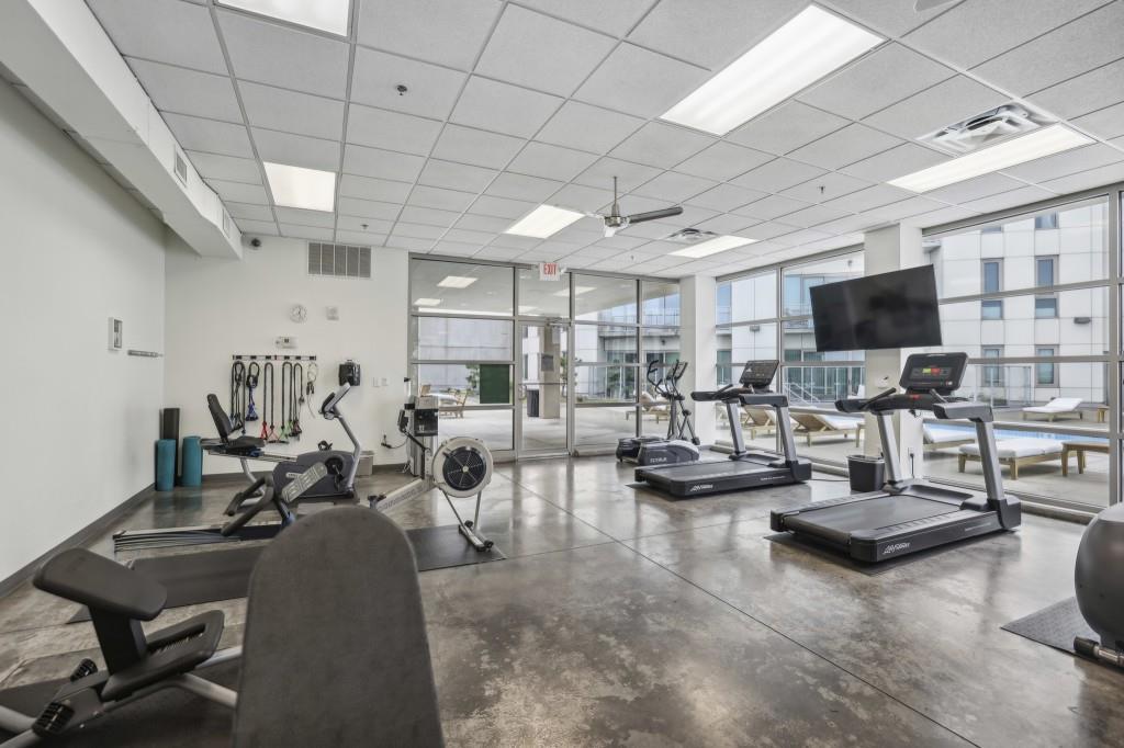 1100 Howell Mill Road Northwest, Unit 808 Atlanta, GA 30318 - Photo 39 of 48 a gym room with lots of furniture and a view of living room