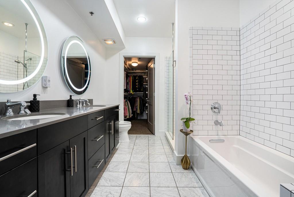 1100 Howell Mill Road Northwest, Unit 808 Atlanta, GA 30318 - Photo 4 of 48 a bathroom with a granite countertop sink a toilet and bathtub