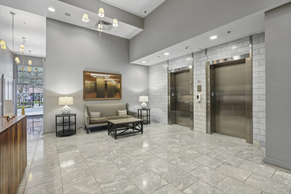 1100 Howell Mill Road Northwest, Unit 808 Atlanta, GA 30318 - Photo 9 of 48 a lobby with furniture and a flat screen tv